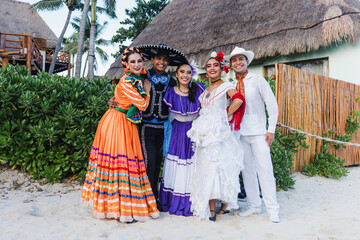 Wall Mural - group of mexican dancers wearing traditional folk costume, young latin people portrait in Mexico Latin America