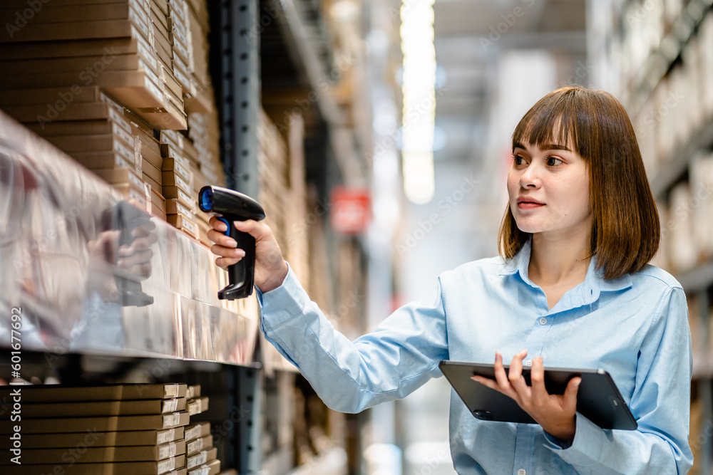 Women worker use scanner to check and scan barcodes of stock inventory ...