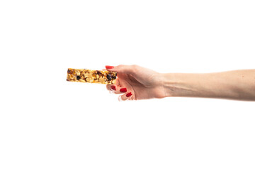 Wall Mural - Healthy granola bar (muesli or cereal bar) isolated on white background. Muesli bar in females hands with red manicure.