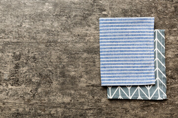 top view with blue kitchen napkin isolated on table background. Folded cloth for mockup with copy space, Flat lay. Minimal style