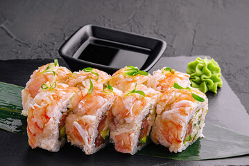 Wall Mural - Fresh sushi rolls with shrimp on a stand with soy sauce