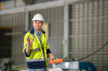 Wall Mural - Factory apprenticeship. Woman mentor teaching man employee trainee operating machine look monitors and hand press control button process machinery. Leader foreman explaining engineer control machine