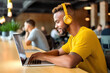 © ADDICTIVE STOCK - A black man working on his laptop in a coworking. Generative AI
