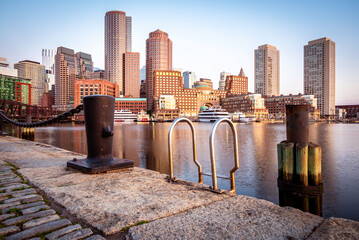 Wall Mural - View of the architecture of Boston in Massachusetts, USA showcasing the Boston Harbor and Financial District from the Fan Pier at sunrise.