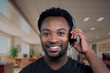 © Jacques Durocher - contact us support center customer service man smiling helpline african office receptionist headset