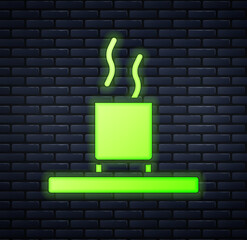 Sticker - Glowing neon Cup of tea icon isolated on brick wall background. Vector