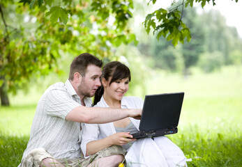 Wall Mural - happy young couple relaxing in park