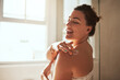 © Chanelle Malambo/peopleimages.com - Skincare, cream and woman in bathroom for wellness, moisturizer and apply lotion for healthy skin. Beauty, self care and female person touch body for grooming, hydration and cosmetics for hygiene