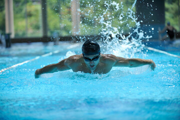 young healthy with muscular body man swim on swimming pool and representing healthy and recreation concept