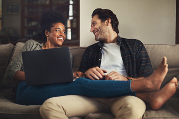 Wall Mural - Laptop, relax and an interracial couple streaming a movie using an online subscription service for entertainment. Computer, watching or internet with a man and woman bonding together over a video