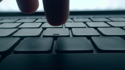 Wall Mural - a program coder is typing on laptop keyboard close up macro. hacker is using computer. man hands are