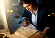 © Angelo J/peopleimages.com - Night, notes or businesswoman reading research or paperwork overtime working on growth strategy. Late, lens flare or focused employee brainstorming ideas for project deadline on internet in office
