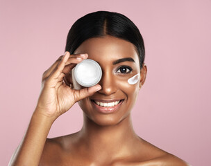 face, skincare and woman with cream container in studio isolated on a pink background. portrait, der