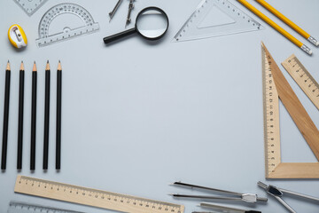 Wall Mural - Flat lay composition with different rulers and compasses on light grey background. Space for text