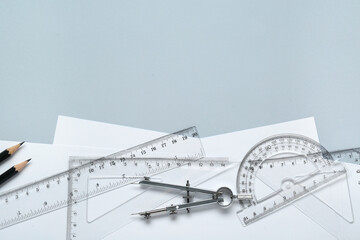 Wall Mural - Flat lay composition with different rulers and compass on light grey background. Space for text