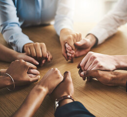 Trust circle, therapy and people holding hands by a wood table at a group counseling or psychology session. Gratitude, spiritual and friends praying together for religion, community and connection.