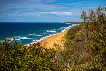 panorama of beautiful long beach with orange sand in deepwater national park south from agnes water and seventeen seventy; unique coast of gladstone region in queensland, australia;