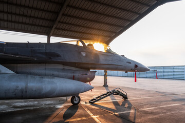 Airplane parking at port against sun light background. 