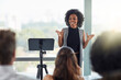 © Viglietti/peopleimages.com - Corporate, businesswoman with presentation and in business meeting in conference room at work. Presenter, happy female speaker and black woman at seminar or workshop speaking with businesspeople