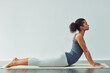© Viglietti/peopleimages.com - Yoga, upward dog and woman stretching on mat for wellness, workout and fitness in gym studio. Healthy body, meditation and female person doing pilates exercise for balance, flexibility and wellbeing