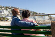 © Wavebreak Media - Senior african american couple sitting on bench and embracing on promenade at seaside