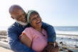 © Wavebreak Media - Happy senior african american couple embracing on promenade at seaside