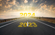 Change of calendar. 2024 anniversary. Transition from 2023 to the new year. Golden sunrise on asphalt empty road. New year concept with the number 2024 on the horizon.