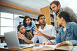 © K Seisa/peopleimages.com - College, talking and students studying in a library for a group project, teamwork and education. Diversity, laptop and friends speaking about university notes, knowledge and planning research
