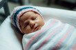 © 1by1step - A newborn baby wrapped in a common flannelette towel white, blue and pink hospital blanket.