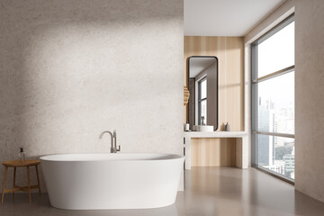 Light bathroom interior with bathtub and sink near panoramic window. Empty wall