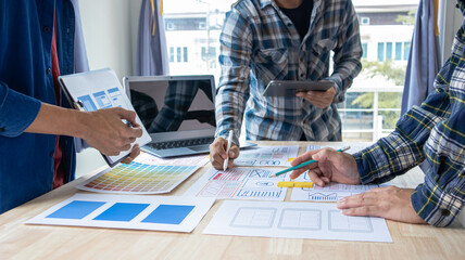 Close-up ux developers and ui designers use augmented reality to brainstorm on mobile app interface wireframe designs on modern office desks. Creative digital development office