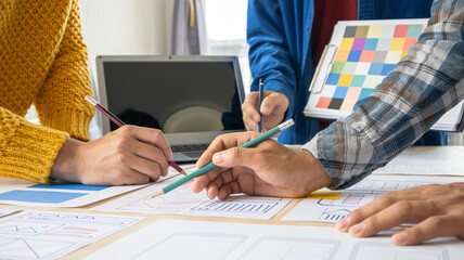Close-up ux developers and ui designers use augmented reality to brainstorm on mobile app interface wireframe designs on modern office desks. Creative digital development office