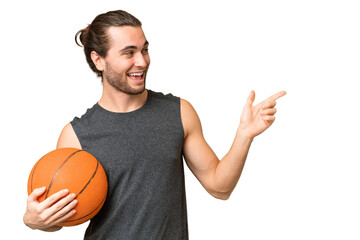 Wall Mural - Young basketball player man over isolated background pointing finger to the side and presenting a product