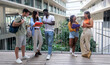 © Gigi Delgado - Cheerful group of young interracial students standing together at high school university campus. Friends gathering during break time.
