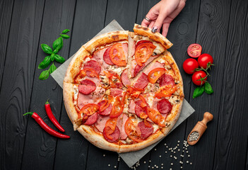 Wall Mural - Italian pizza with ham, sausage, mushrooms, tomatoes and onions.