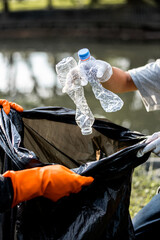 Man picking up plastic waste to clean up at a park