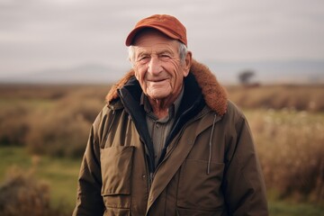 Poster - Medium shot portrait photography of a pleased man in his 80s wearing a warm parka against a cotton field or plantation background. Generative AI