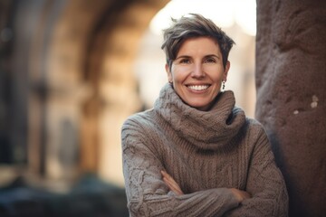 Poster - Portrait of a smiling middle-aged woman standing outdoors in winter