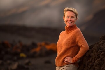 Poster - Environmental portrait photography of a pleased woman in her 40s wearing a cozy sweater against a volcano or lava background. Generative AI