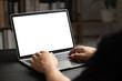Leinwandbild Motiv Mockup of man using and typing on laptop with blank white desktop screen.