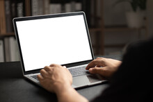 Mockup Of Man Using And Typing On Laptop With Blank White Desktop Screen.