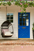 Charming Beach Bungalow With Bright Blue Front Door And Hanging Egg Chair