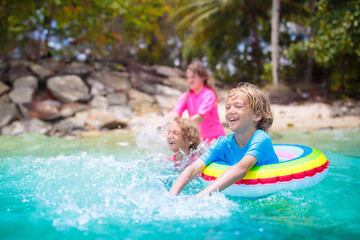 Wall Mural - Kids playing on tropical beach. Summer fun.