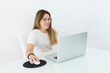 © Vanesa Flores - Young pretty caucasian woman in glasses working on laptop