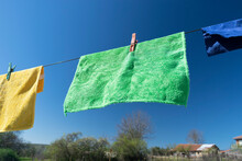 Clothes Peg On A Towel And Washing Line Against A Blue Sky