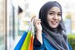 Confident happy smiling Muslim woman shopper doing shopping in neighborhood mall, concept of buying, grand sale, boxing day, celebration sale, discount, good deal for woman shoppers