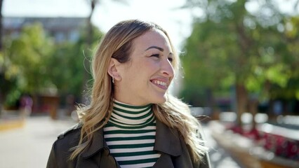 Wall Mural - Young beautiful hispanic woman smiling confident at park