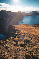 Wall Mural - Top angle view of a backpacker walking down from the foothills of an island in the Atlantic Ocean. São Lourenço, Madeira Island, Portugal, Europe.