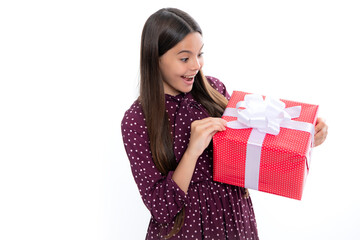 Sticker - Emotional teenager child hold gift on birthday. Funny kid girl holding gift boxes celebrating happy New Year or Christmas. Portrait of emotional amazed excited teen girl.