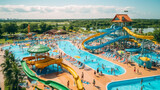 Fototapeta  - A fun and colorful photo of a water park with slides and pools, showing the people enjoying the water attractions and the sunny day.  Generative AI.